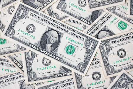 One dollar banknotes as background. Spread out 1 usd bills top down view. US dollar currency.