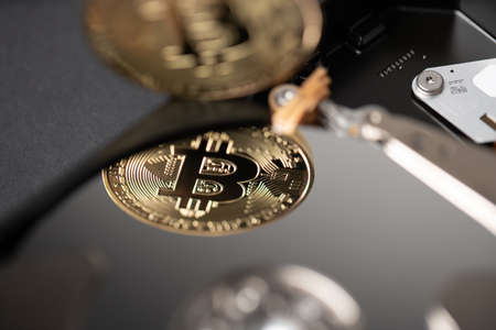 Bitcoin reflection on hard drive disk, concept of storing and saving block chain of crypto currenciesの写真素材