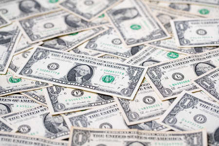 One dollar banknotes as background. Spread out 1 usd bills forming a pattern