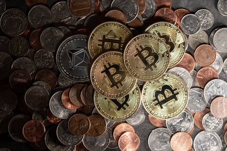 Piled up money coins, US Dollar coins, Penny, Dime and Quarter with Gold Bitcoin coins on top. Crypto and Dollar backgroundの写真素材