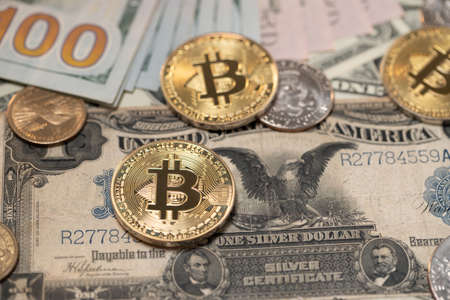Gold Bitcoin coins on historic one Dollar banknote. Large Dollar bill, Black Eagle banknotes