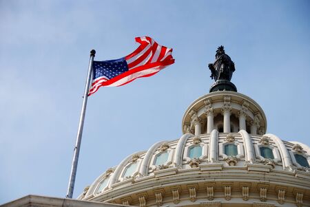 US national flag flying over Capitol Hill Building in Washington DCの写真素材
