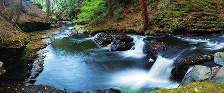 Forest creek panorama view with rocks and Autumn treesの写真素材