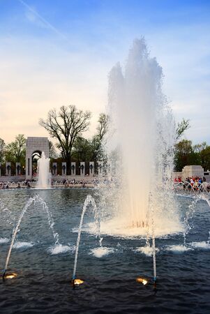 Fountain in World War II memorial, Washington DC, at dusk with lightsのeditorial素材
