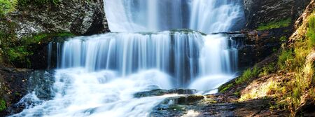 Waterfall panorama in Autumn with rocks and foliageの写真素材