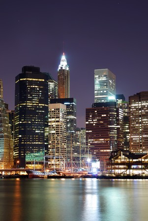 New York City Manhattan skyline with office skyscrapers building in at dusk illuminated with lights at night over Hudson Riverの写真素材