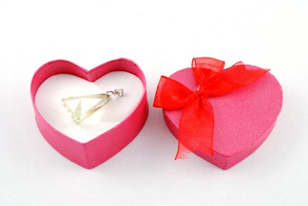 heart shape gift box in red color with crystal pendant with white backgroundの写真素材