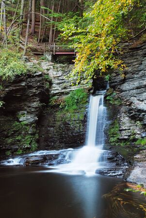 Waterfall with trees and rocks in mountain in Autumn. From Pennsylvania Dingmans Falls.の写真素材
