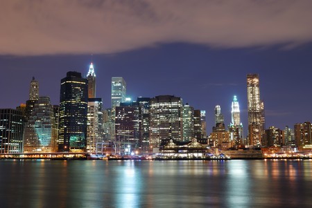 New York City Manhattan skyline with office skyscrapers building in at dusk illuminated with lights at night over Hudson Riverの写真素材