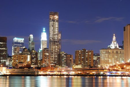 New York City Manhattan skyline with office skyscrapers building in at dusk illuminated with lights at night over Hudson Riverの写真素材