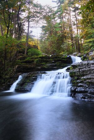 Waterfall with trees and rocks in mountain in Autumn. From Pennsylvania Dingmans Falls.の写真素材