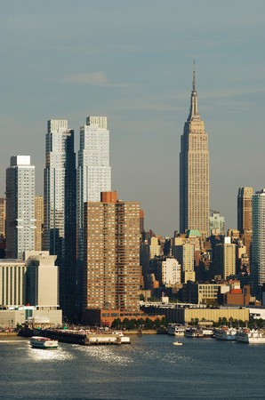 Empire State Building with New York City Manhattan skyline at dusk with skyscrapers with reflection over Hudson river.の写真素材