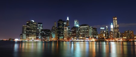 New York City Manhattan skyline panorama with office skyscrapers building illuminated with lights at nightの写真素材