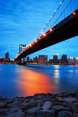 New York City Manhattan bridge and Manhattan skyline at dusk.の写真素材