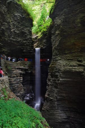 Waterfall in woods with rocks and stream in Watkins Glen state park in New York Stateの写真素材