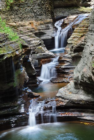Waterfall in woods with rocks and stream in Watkins Glen state park in New York Stateの写真素材