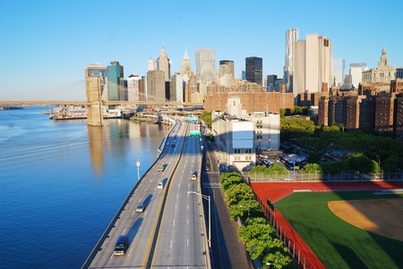 New York City Manhattan skyline with Brooklyn Bridge and skyscrapers over Hudson River in the morning after sunrise.の写真素材