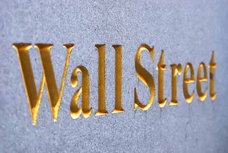 New York City Wall Street road sign in downtown Manhattan with skyscrapers. の写真素材