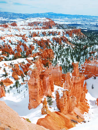 Bryce canyon panorama with snow in Winter with red rocks and blue sky. の写真素材