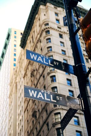 New York City Wall Street road sign in downtown Manhattan with skyscrapers. の写真素材