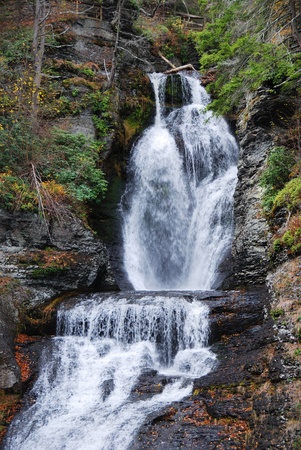 Waterfall in Autumn mountain with woods, foliage and rocks. From Digmans Fall of Pennsylvaniaの写真素材