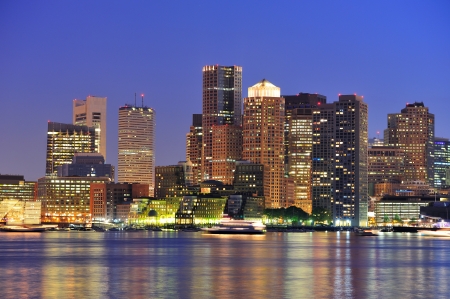 Boston downtown at dusk with urban buildings illuminated at dusk after sunset. の写真素材