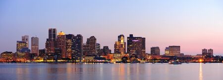 Boston downtown at dusk with urban buildings illuminated at dusk after sunset. の写真素材