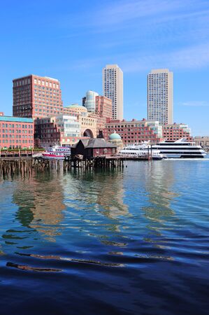 Boston waterfront with skyscrapers and boat in the morning.の写真素材