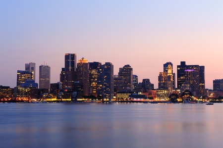 Boston downtown at dusk with urban buildings illuminated at dusk after sunset. の写真素材
