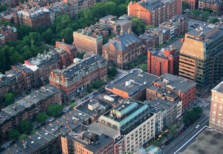 Boston city downtown aerial view with urban historical buildings at sunset.の写真素材