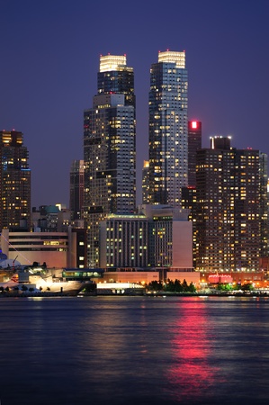 Urban modern architecture in New York City midtown Manhattan at dusk over river.のeditorial素材