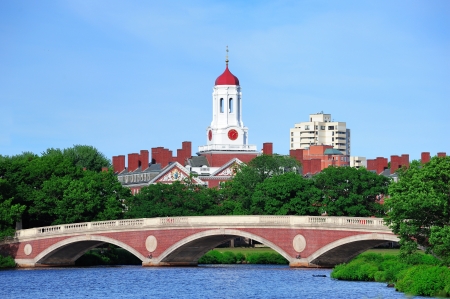 John W. Weeks Bridge and clock tower over Charles River in Harvard University campus in Boston with trees and blue sky.のeditorial素材