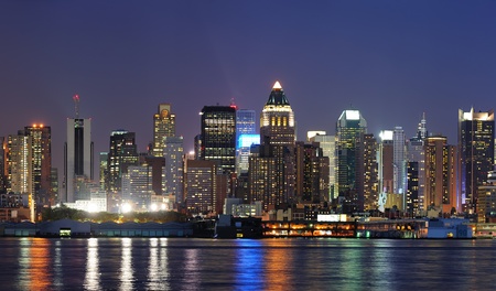New York City Manhattan midtown skyline panorama at dusk with historical landmark skyscrapers over Hudson River viewed from New Jersey Weehawken waterfront.の写真素材