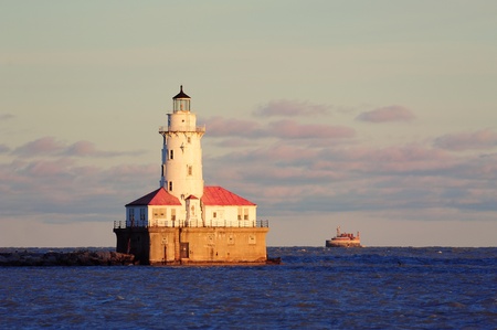 Chicago Light House with boat in Lake Michigan with cloud and blue sky at sunset.の写真素材
