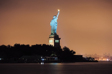 Statue of Liberty at night lit by lights in Liberty Park in New York City.のeditorial素材
