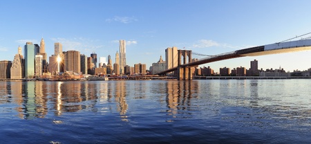 Brooklyn Bridge with lower Manhattan skyline panorama in the morning with cloud and river reflection over East River in New York Cityの写真素材
