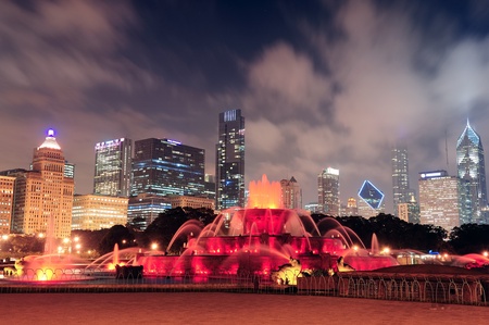Chicago skyline with skyscrapers and Buckingham fountain in Grant Park at night lit by colorful lights.のeditorial素材