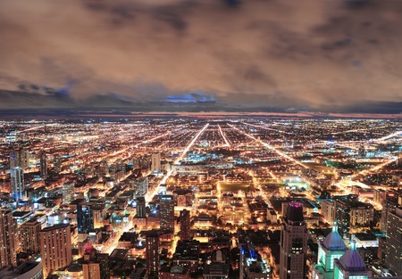 Chicago urban skyline panorama aerial view with skyscrapers and cloudy sky at dusk with lights.のeditorial素材