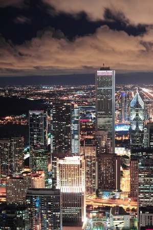 Chicago urban skyline panorama aerial view with skyscrapers and cloudy sky at dusk with lights.のeditorial素材
