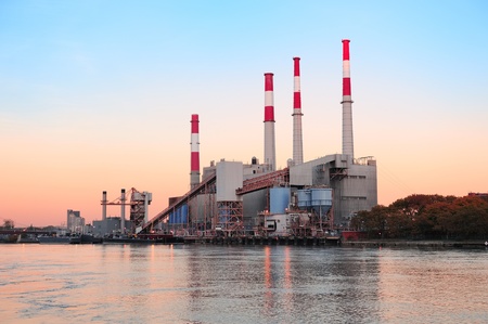 Factory over river at dusk