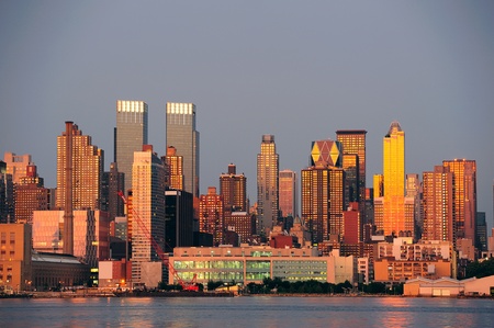 New York City Manhattan sunset panorama with historical skyscrapers over Hudson River with beautiful red color sunshine reflection viewed from New Jersey Weehawken waterfront. の写真素材