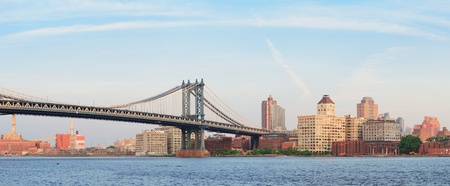 Manhattan Bridge panorama over East River viewed from New York City Lower Manhattan waterfront at sunset.のeditorial素材