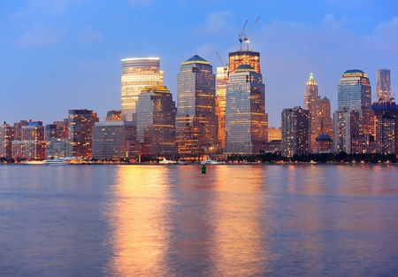 New York City Manhattan downtown skyline at dusk with skyscrapers illuminated over Hudson River panoramaのeditorial素材