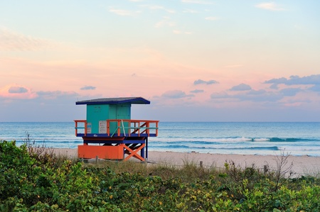 Miami South Beach sunset with lifeguard tower and coastline with colorful cloud and blue sky.のeditorial素材
