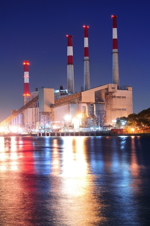 Factory over river at duskの写真素材