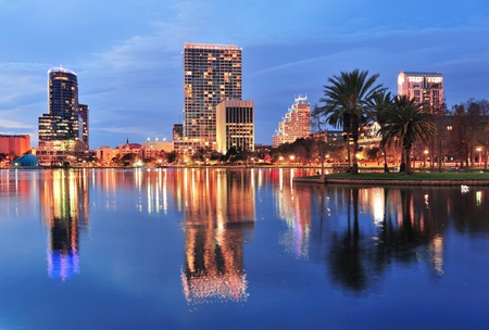 Orlando downtown skyline over Lake Eola at dusk with urban skyscrapers and lights.の写真素材