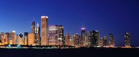Chicago city downtown urban skyline panorama at dusk with skyscrapers over Lake Michigan with clear blue sky.の写真素材