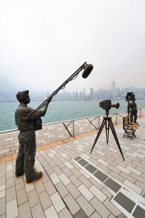 HONG KONG, CHINA - APR 17: Statue and skyline in Avenue of Stars on April 17, 2012 in Hong Kong, China. The promenade honours celebrities of the Hong Kong film industry as the famous city attraction.のeditorial素材
