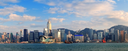 Hong Kong Victoria Harbor in afternoon with urban city skyline and colorful cloudの写真素材