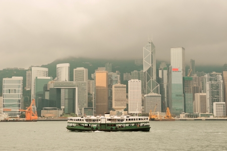 Hong Kong skyline with boats in Victoria Harbor in yellow tone. の写真素材